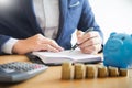 Business accounting man hands working stacking coin the calculator, calculating, financial investment planning and saving concept Royalty Free Stock Photo