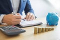 Business accounting man hands working stacking coin the calculator, calculating, financial investment planning and saving concept Royalty Free Stock Photo