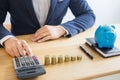 Business accounting man hands working stacking coin the calculator, calculating, financial investment planning and saving concept Royalty Free Stock Photo