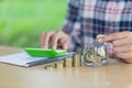 Business accounting with saving money with hand putting coins in jug glass, Businessman Writing Financial Accounting, concept Royalty Free Stock Photo