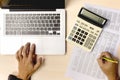 Business accounting using calculator and computer laptop for analyzing investment finance report on desk office Royalty Free Stock Photo