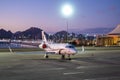 Business Airplane Parking Outside The Terminal In Airport. Private Jet Airliner, Luxury Corporate Aircraft, Airport Lights Royalty Free Stock Photo