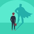 Business ambition and success concept. Businessman with superhero shadow as symbol of power, leadership.
