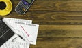 Business analysis chart with laptop and calculator on a brown wooden table Royalty Free Stock Photo