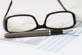 Business Analysis and Report with pen, glasses and chart