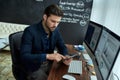 Business analysis. Young focused businessman, financial analyst or sales manager sitting at his workplace in the office