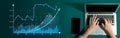 Business analytics and financial growth charts displayed on a screen while hands type on a laptop keyboard in a modern Royalty Free Stock Photo
