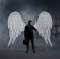 Business angel with a suitcase on city ruins