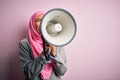 Business arab woman wearing hijab shouting angry on protest through megaphone Royalty Free Stock Photo