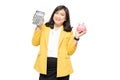 Business asian lady people in yellow suit holding calculator and piggy bank isolated on white background; finance economy banking Royalty Free Stock Photo