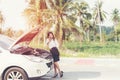 Business asian woman with a broken car calling for assistance. Royalty Free Stock Photo