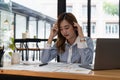 Business asian woman get stressed and headache while having a problem at work in office Royalty Free Stock Photo