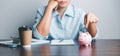 Business asian woman hand put coins in piggy bank on wood table background, saving money wealth and financial concept, finance, Royalty Free Stock Photo