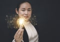 Business Asian woman Holding Illuminated Light Bulb with innovative and creativity are keys to success,innovation and inspiration, Royalty Free Stock Photo
