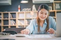 Business asian woman sitting at a desk at an office By using the calculator to work. Business Concept Analysis and Planning Royalty Free Stock Photo