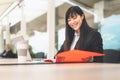 Business Asian woman working on computer outdoor - Happy Chinese girl using laptop in office Royalty Free Stock Photo
