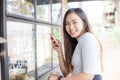 Business asian women texting on smart phone in modern coffe shop