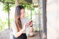 Business asian women texting on smart phone in modern coffe shop