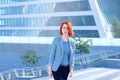 Business attractive women walking down the street on a background of a skyscraper Royalty Free Stock Photo