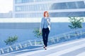 Business attractive women walking down the street on a background of a skyscraper Royalty Free Stock Photo