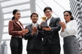 Business background of asian business people being cheerful for being winner in business competition contest with hand holding