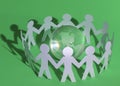 Group of paper men standing around the glass globe Royalty Free Stock Photo