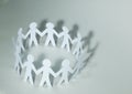 Business background.team paper men standing holding hands. Royalty Free Stock Photo