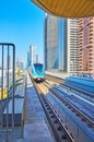 Business Bay Metro Station and riding train, on March 6 in Dubai, UAE