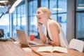 Business blonde woman taking on the phone and laughing in front Royalty Free Stock Photo