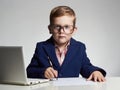 Business boy. funny child in glasses writing pen. little boss in office