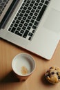 Business breakfast with cafe, muffin, laptop and cellphone Royalty Free Stock Photo