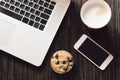 Business breakfast with cafe, muffin, laptop and cellphone Royalty Free Stock Photo