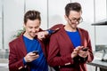 Business brothers twins with phones Royalty Free Stock Photo