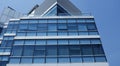 Business building in city with mirror windows with reflections.