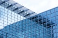 Business building with modern glass exterior on blue sky background. Royalty Free Stock Photo