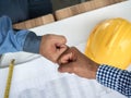 Business, building, teamwork, gesture and people concept - group of smiling builders in hardhats greeting each other with Hand Royalty Free Stock Photo