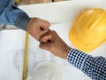 Business, building, teamwork, gesture and people concept - group of smiling builders in hardhats greeting each other with Hand Royalty Free Stock Photo