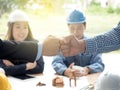 Business, building, teamwork, gesture and people concept - group of smiling builders in hardhats greeting each other with Hand Royalty Free Stock Photo