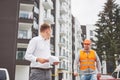 Business, building, teamwork and people concept - group of smiling builders in hardhats at construction site Royalty Free Stock Photo