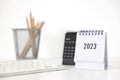 2023 business calendar, keyboard and pencil on office table in new year day. Make a work plan for the start of the year. Concept