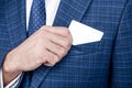 Business card being pulled out of formal suit pocket, contact info for copy space