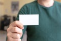 Business Card Mock-Up - Man Holding a Blank Card for Clients. Business Card Template