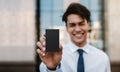 Business Card Mockup Image. Happy Young Businessman Presenting a Black Blank Card is Clipping Path