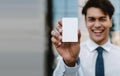 Business Card Mockup Image. Happy Young Businessman Presenting a White Blank Paper Card Royalty Free Stock Photo