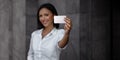 Business Card Mockup Image. a Smiling Mixed Races Business Woman showing a Blank Card