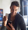 Business card, phone and young man in cafe dial mobile number for communication or call. Smile, contact paper and male Royalty Free Stock Photo