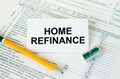 Business card with text Home Refinance on financial docs Royalty Free Stock Photo