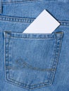 A business card is visible from a blue denim pocket. Royalty Free Stock Photo
