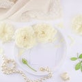 Business cards mockup on a white plate with roses and pearl necklace. Royalty Free Stock Photo