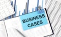 BUSINESS CASES text on blue sticker on the chart background near calculator Royalty Free Stock Photo